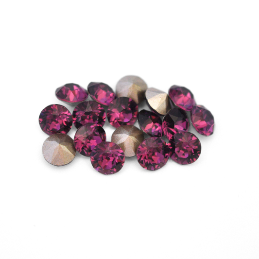 Round faceted Austrian crystal rhinestones in the color Amethyst displayed on a white background