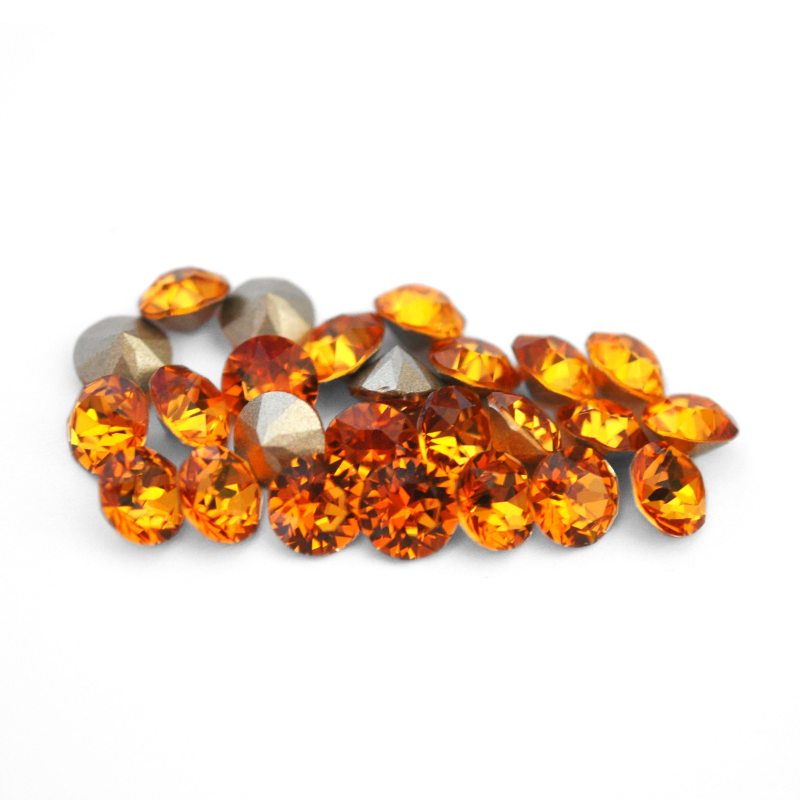 Round faceted Austrian crystal rhinestones in the color Dark Orange displayed on a white background