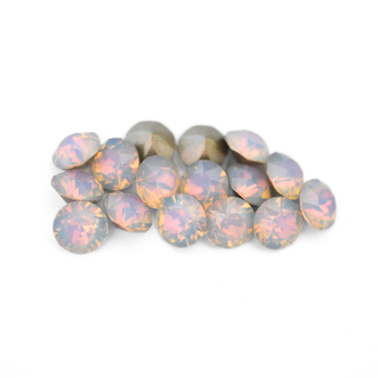 Round faceted Austrian crystal rhinestones in the color Dreamy Vitrail displayed on a white background