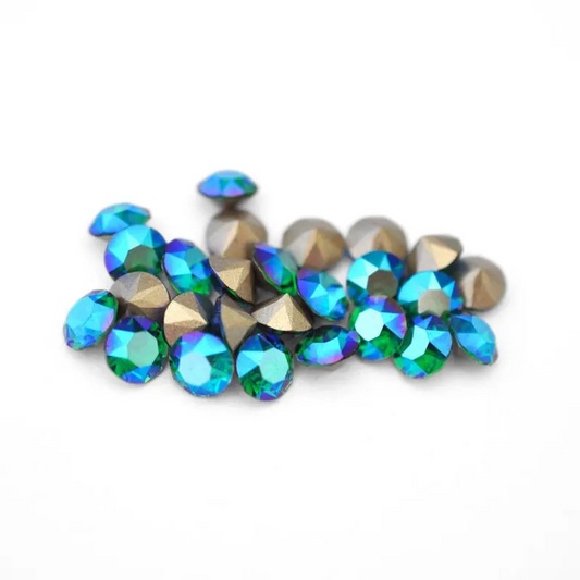 Round faceted Austrian crystal rhinestones in the color Majestic Green Shimmer displayed on a white background