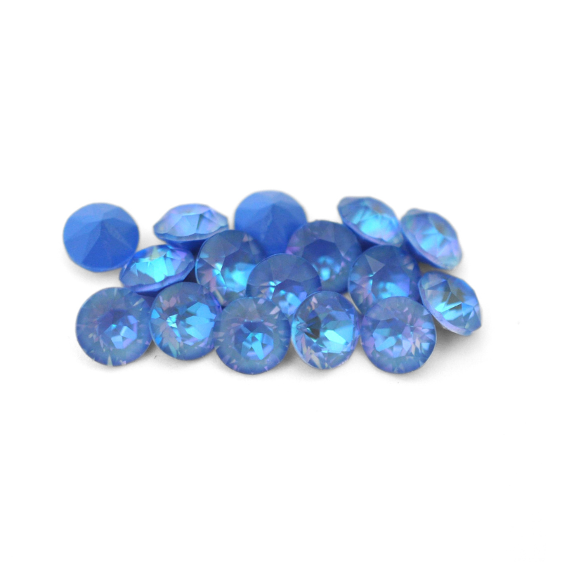Round faceted Austrian crystal rhinestones in the color Ocean Delite displayed on a white background
