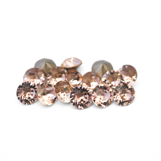 Round faceted Austrian crystal rhinestones in the color Silk displayed on a white background