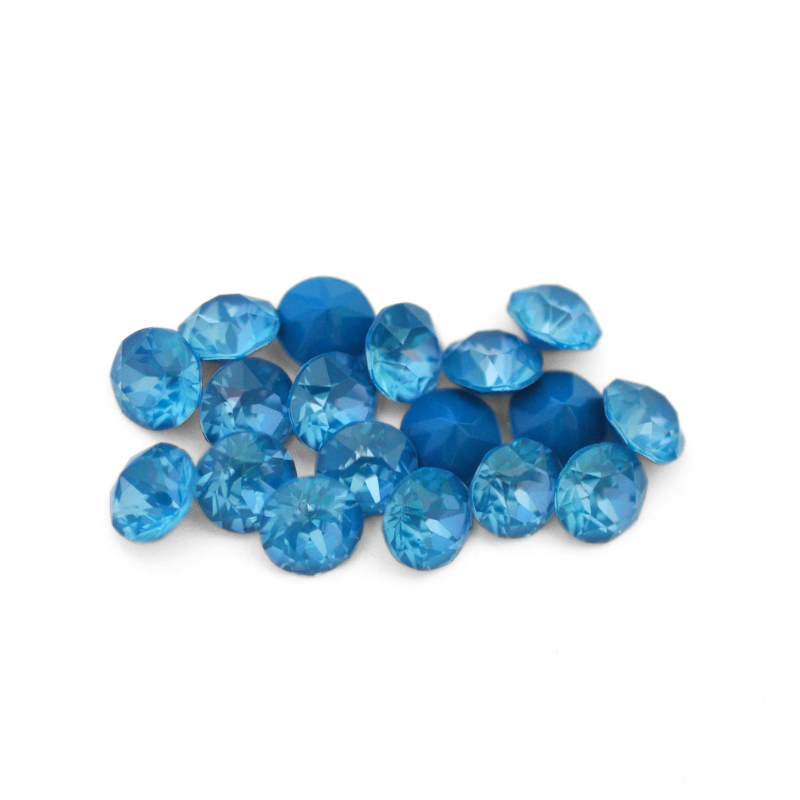 Round faceted Austrian crystal rhinestones in the color Teal Ignite displayed on a white background