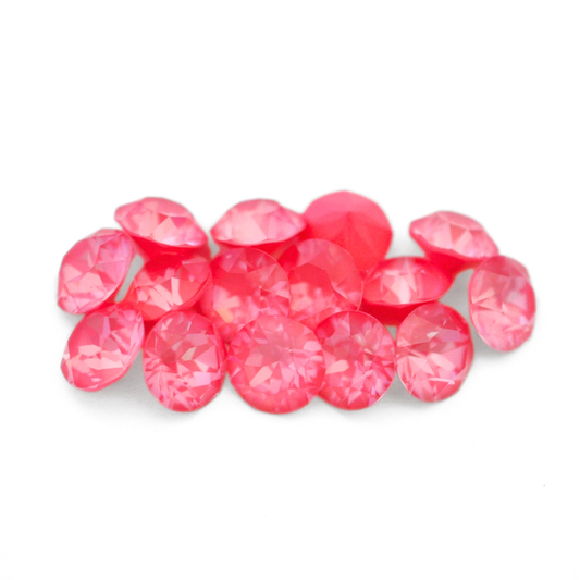 Round faceted Austrian crystal rhinestones in the color Lotus Ignite displayed on a white background