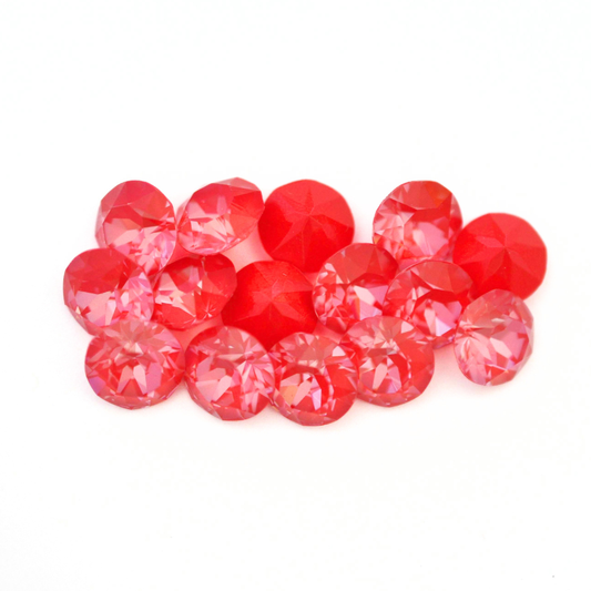 Round faceted Austrian crystal rhinestones in the color Poppy Red Ignite displayed on a white background