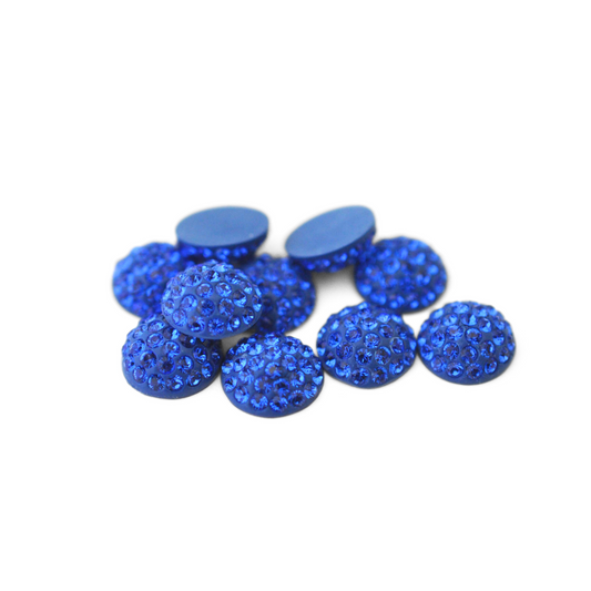 Round Pave Cabochons with Austrian crystal rhinestones in the color Majestic Blue displayed on a white background